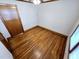 Hardwood floors and paneled door in bedroom space at 807 Everett St, Burlington, NC 27215