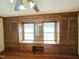 Charming bedroom featuring hardwood floors, built-in storage with a desk, and ample natural light at 807 Everett St, Burlington, NC 27215
