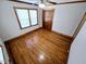Sunlit bedroom with gleaming hardwood floors, ceiling fan and natural light at 807 Everett St, Burlington, NC 27215