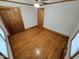 Cozy bedroom showcasing hardwood floors, a ceiling fan, and a convenient closet at 807 Everett St, Burlington, NC 27215