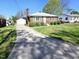 Charming brick home featuring a long driveway and detached garage at 807 Everett St, Burlington, NC 27215