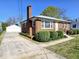 Traditional brick home with a detached garage and a long driveway at 807 Everett St, Burlington, NC 27215
