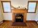 Living room fireplace with a tile hearth and wood trim at 807 Everett St, Burlington, NC 27215
