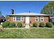 Charming brick home featuring a classic design, well-maintained landscaping, and a welcoming entrance at 807 Everett St, Burlington, NC 27215