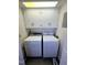 Functional laundry area with white cabinets above vintage-style washer and dryer units at 807 Everett St, Burlington, NC 27215