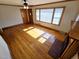 Bright living room featuring hardwood floors, a fireplace, a ceiling fan, and natural light at 807 Everett St, Burlington, NC 27215