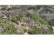 An aerial shot of a secluded property nestled among lush trees with a winding driveway leading to the house at 90 Ferncrest Ct, Roxboro, NC 27574