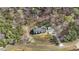 Overhead view of a house surrounded by dense trees, showcasing a large driveway and well-maintained yard at 90 Ferncrest Ct, Roxboro, NC 27574