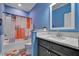 Stylish bathroom featuring a tub with shower, gray vanity and colorful decor at 90 Ferncrest Ct, Roxboro, NC 27574