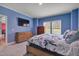 Comfortable bedroom with a flat-screen TV, carpet flooring and a bright window with natural light at 90 Ferncrest Ct, Roxboro, NC 27574