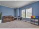 Bright and comfortable bonus room featuring a leather couch, neutral walls, carpet flooring and natural light at 90 Ferncrest Ct, Roxboro, NC 27574
