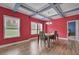 Elegant dining space with stylish light fixture, hardwood floors, natural light, and a peek into the bedroom at 90 Ferncrest Ct, Roxboro, NC 27574