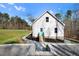 View of the backyard, showcasing the light-colored facade and tasteful landscaping at 90 Ferncrest Ct, Roxboro, NC 27574