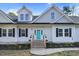 Attractive exterior displaying blue front door flanked by windows, flower boxes, and complementary landscape design at 90 Ferncrest Ct, Roxboro, NC 27574