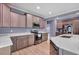 Modern kitchen featuring stainless steel appliances, granite countertops, custom cabinets and updated hardwood floors at 90 Ferncrest Ct, Roxboro, NC 27574