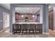 Modern kitchen featuring an island with barstool seating, stainless appliances, and pendant lighting at 90 Ferncrest Ct, Roxboro, NC 27574