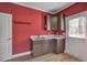 Inviting laundry room with wood-look flooring, stylish cabinets, and a utility sink at 90 Ferncrest Ct, Roxboro, NC 27574