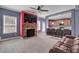 Cozy living area with stone fireplace, large TV, and seamless flow into the kitchen area with bar seating at 90 Ferncrest Ct, Roxboro, NC 27574