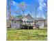 Back of home featuring a wooden deck overlooking the spacious backyard at 908 Snow Hill Rd, Durham, NC 27712