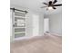 Bedroom featuring neutral carpet, a modern ceiling fan, and a stylish sliding door at 908 Snow Hill Rd, Durham, NC 27712