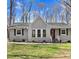 Charming single-story home with a well-maintained lawn, dark shutters, and inviting front entrance at 908 Snow Hill Rd, Durham, NC 27712