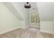 Carpeted attic room with a window and sloped walls at 924 Elbridge Dr, Raleigh, NC 27603