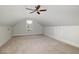 Carpeted attic room with a window and door to storage area at 924 Elbridge Dr, Raleigh, NC 27603