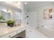 Bright bathroom featuring double sinks, a soaking tub, and ample counter space for a luxurious experience at 924 Elbridge Dr, Raleigh, NC 27603