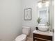 Stylish half bathroom featuring a modern vessel sink, elegant fixtures, and a contemporary art piece at 924 Elbridge Dr, Raleigh, NC 27603