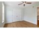 A cozy bedroom with a closet with paneled doors and hardwood floors at 924 Elbridge Dr, Raleigh, NC 27603