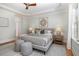 Serene bedroom showcasing a plush bed, calming decor, and large windows offering natural light and peaceful views at 924 Elbridge Dr, Raleigh, NC 27603