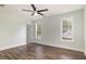 Spacious bedroom with two windows, ceiling fan, and wood-look floors at 924 Elbridge Dr, Raleigh, NC 27603
