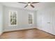 Bright bedroom with two windows, hardwood floors, and ceiling fan at 924 Elbridge Dr, Raleigh, NC 27603