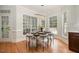 Cozy dining area with a modern chandelier, hardwood floors, and large windows at 924 Elbridge Dr, Raleigh, NC 27603