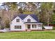 Charming white two-story home with a welcoming front porch and a well-manicured lawn at 924 Elbridge Dr, Raleigh, NC 27603