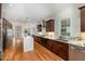 Modern kitchen with stainless steel appliances, a center island, and dark wood cabinetry at 924 Elbridge Dr, Raleigh, NC 27603