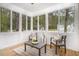Relaxing screened porch with comfortable seating, ideal for enjoying outdoor views in a serene setting at 924 Elbridge Dr, Raleigh, NC 27603
