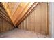 Unfinished attic showcasing the exposed wood beams and insulation, offering potential for customization at 924 Elbridge Dr, Raleigh, NC 27603