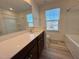 Bathroom features wood-look floors, a bright window, and a large vanity at 93 Steel Springs Ln, Angier, NC 27501