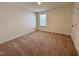 Bedroom features neutral walls, plush carpeting, a window, and an interior door at 93 Steel Springs Ln, Angier, NC 27501