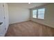 Bedroom with neutral walls, plush carpeting, and a bright window, creating a cozy space at 93 Steel Springs Ln, Angier, NC 27501