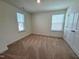 Bedroom features neutral walls, plush carpeting, and bright double windows, creating an inviting space at 93 Steel Springs Ln, Angier, NC 27501