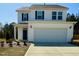 Charming two-story home featuring a spacious two-car garage and manicured lawn at 93 Steel Springs Ln, Angier, NC 27501