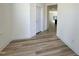 A light and airy hallway boasts sleek wood floors and neutral paint, creating a modern feel at 93 Steel Springs Ln, Angier, NC 27501