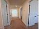 Hallway with carpet and multiple doorways, creating an easy flow between rooms at 93 Steel Springs Ln, Angier, NC 27501