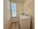 Practical laundry room featuring washer, dryer, and a storage shelf for convenience at 93 Steel Springs Ln, Angier, NC 27501