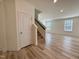 Bright and spacious living area with hardwood floors and a staircase leading upstairs at 93 Steel Springs Ln, Angier, NC 27501