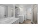 Bright bathroom features a double vanity, tile flooring, and glass-enclosed shower at 1009 Shovelhead Dr # 5, Durham, NC 27703