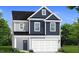 Charming two-story home featuring gray and navy blue siding with a two-car garage at 1009 Shovelhead Dr # 5, Durham, NC 27703