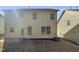 Back exterior of home featuring neutral siding, dual windows, and a backyard area at 106 Canvasback Dr, Durham, NC 27704